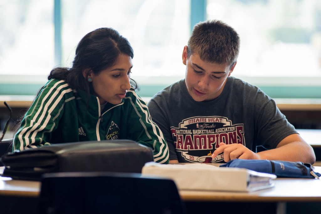 Jaslyen Singh helps a student with his French homework.