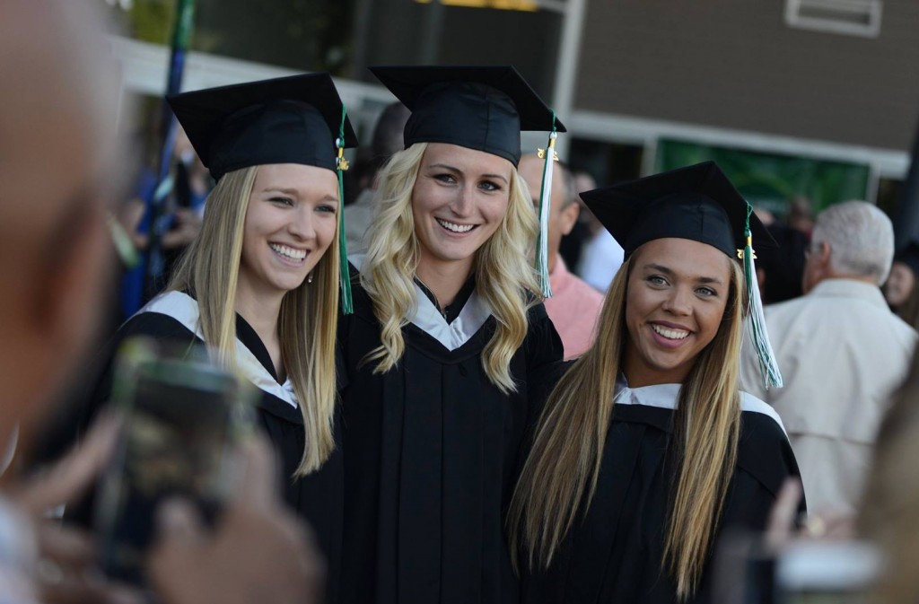 Courtney Bartel, Sarah Wierks and Aieisha Luyken, formerly of the Cascades women's basketball team, pose for photos outside Abbotsford Centre following Thursday afternoon's convocation ceremony. All three received Bachelor of Kinesiology degrees. (Darren McDonald photo)