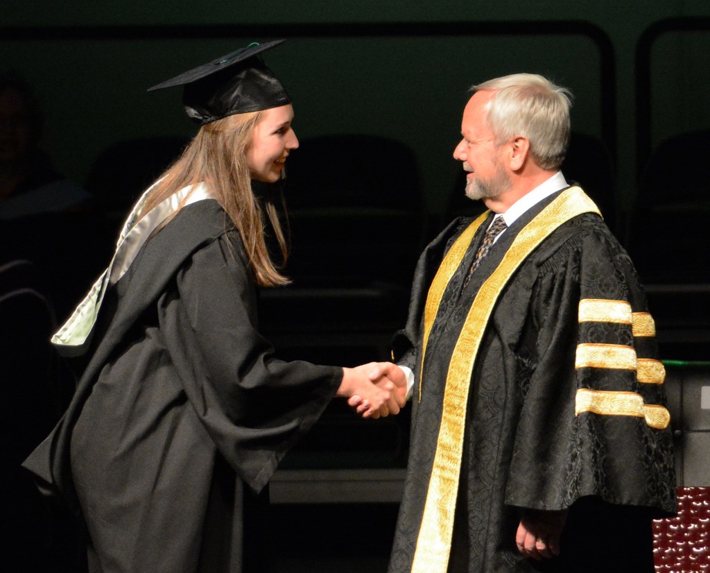 Suzanne Kubat of the Cascades rowing team received congratulations from Dr. Mark Evered on her Bachelor of Kinesiology degree.