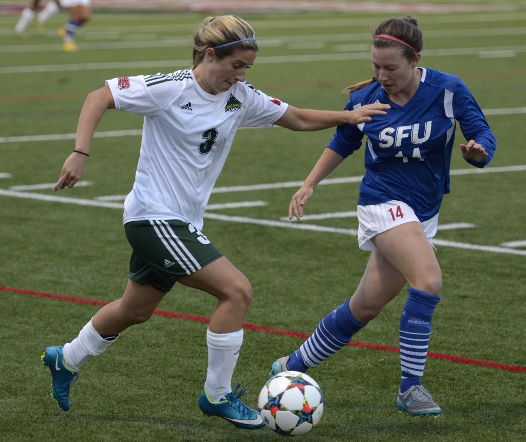 Danica Kump of the Cascades looks for room to operate against SFU's Tanis Cuthbert during Wednesday's exhibition game at Abbotsford Senior Secondary.