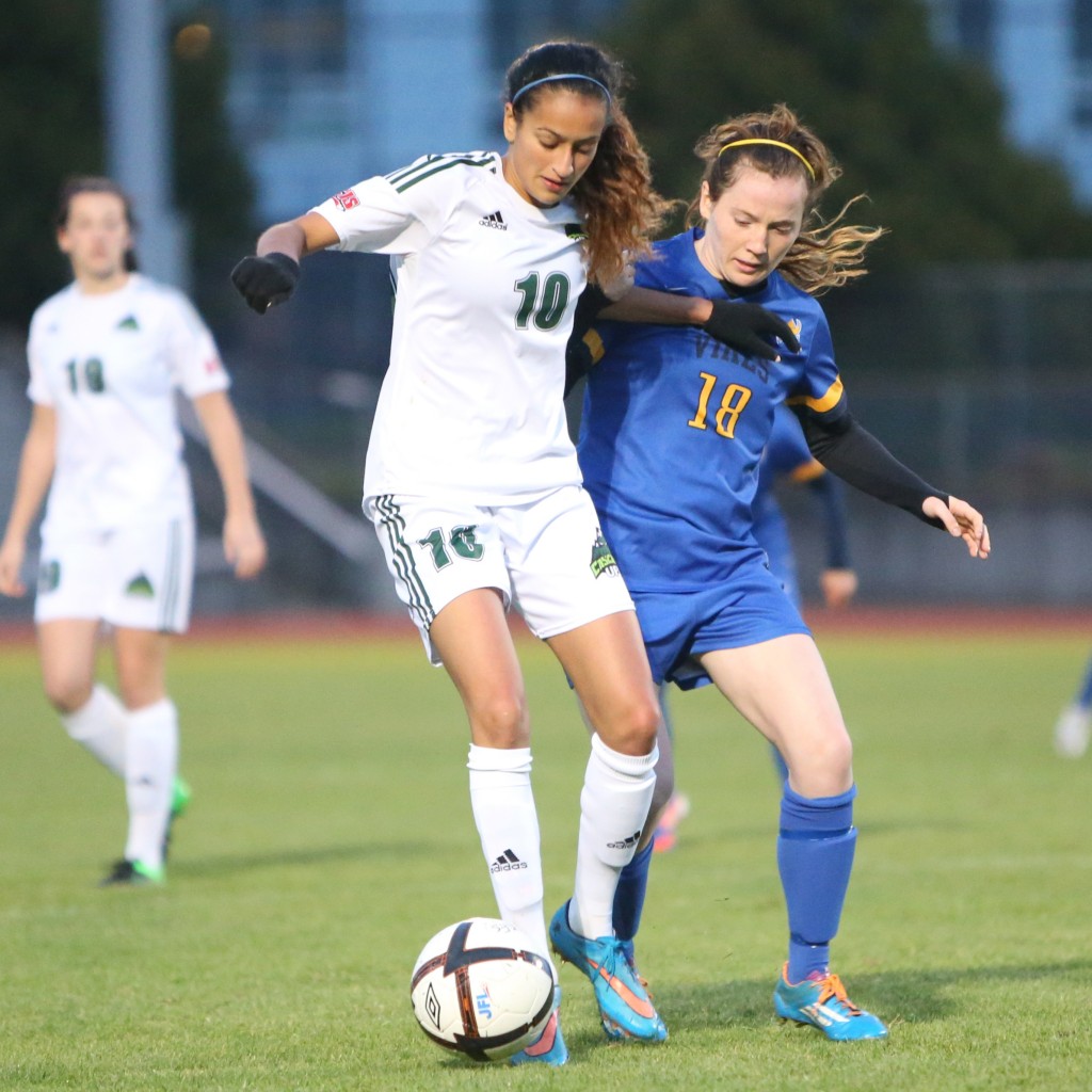 Cascades midfielder Harman Billen protects the ball against pressure from a UVic opponent on Saturday. (APShutter.com photo)