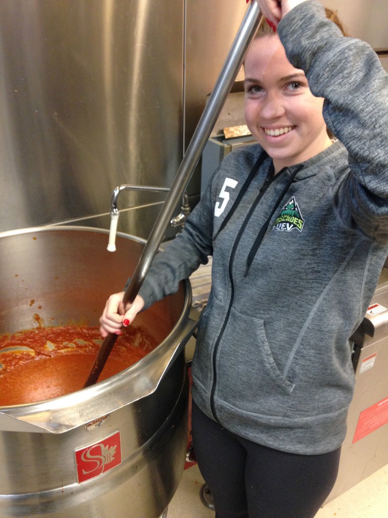 Megan Theroux stirs the meat sauce.