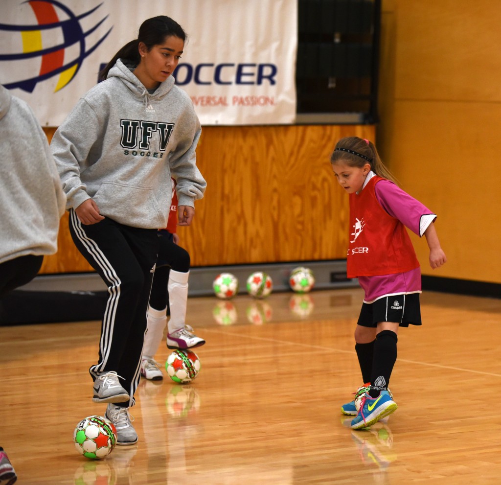 Lexi Gillette, an incoming player with the Cascades women's soccer team, works on skills with a young player during last week's futsal festival at UFV. (Peter Lonergan photo / BC Soccer)