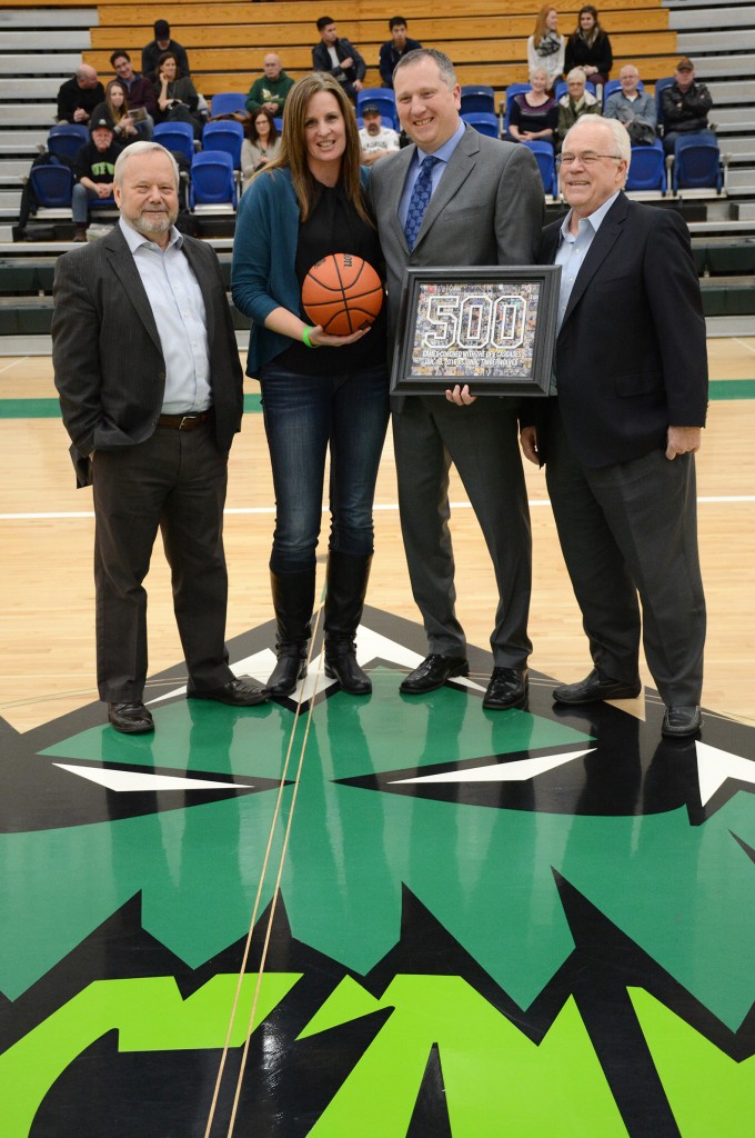 UFV president Dr. Mark Evered (left) and past president Dr. Skip Bassford (right) joined Al Tuchscherer and his wife Denise in a post-game ceremony to celebrate Tuchscherer's 500th game as head coach of the Cascades.