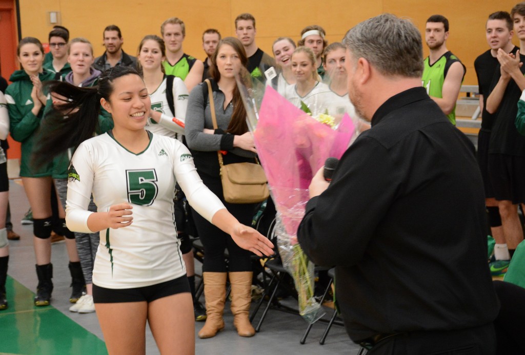 Libero Ray Flores, a fourth-year player who is set to graduate, received flowers from coach Mike Gilray.