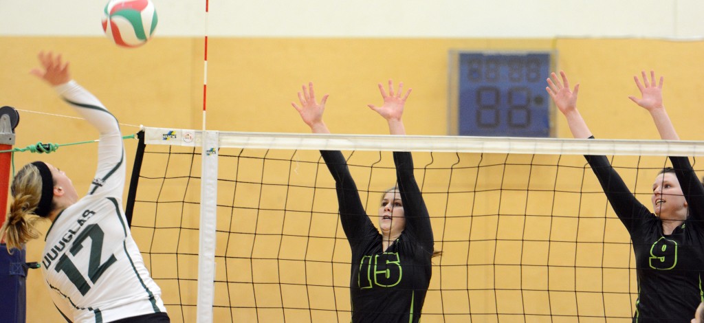 Kara Williams and Mandelyn Erikson of the Cascades go up for a block during Saturday's game vs. Douglas.