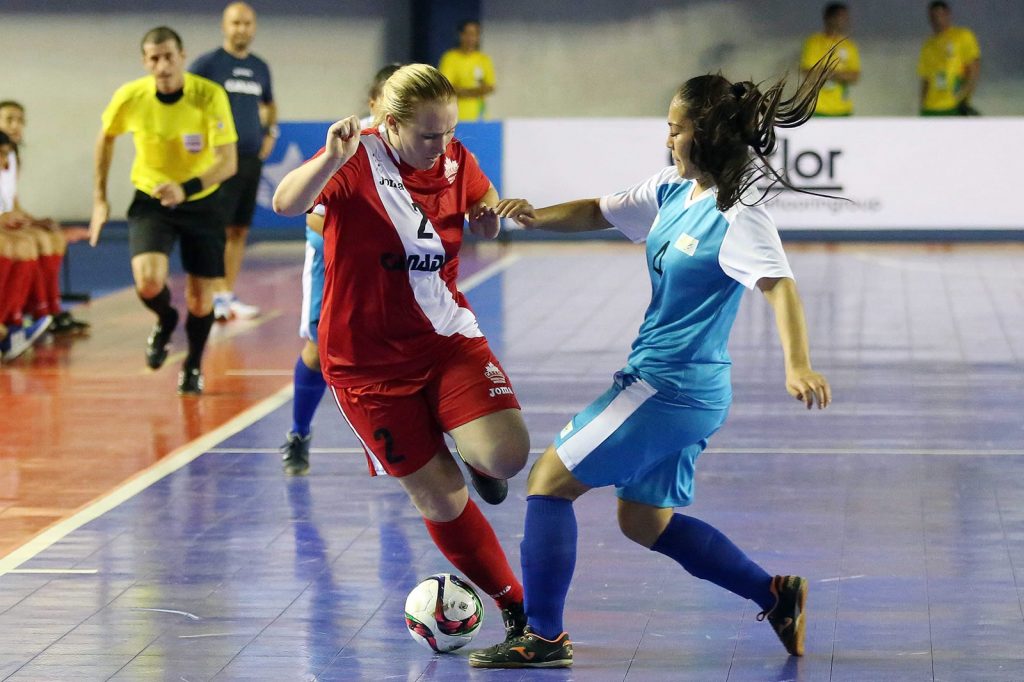 Shelby Beck (left) works her way around a Kazakhstan defender during World University Futsal Championship action on Sunday. (FotoJump / wucfutsal2016.com)