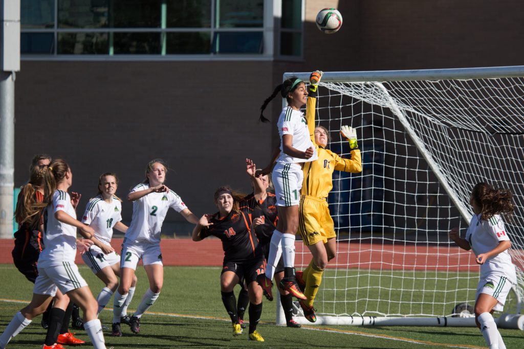 Simi Lehal of the Cascades goes up for a header against TRU keeper Alyssia Smith. (Andrew Snucins photos)