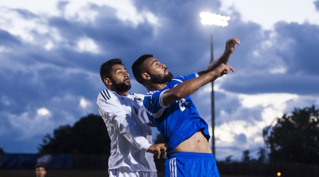 UFV's Sukh Dhaliwal (left) goes up for a header against UBC's Manpal Brar.