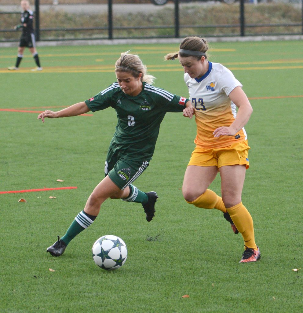 The Cascades' Danica Kump battles for the ball with UVic's Mia Gunter.